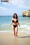 Brunette MILF Lorna Morgan releases her nice melons from bikini on a beach