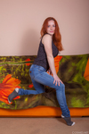 Natural redhead Sara Nikol uncorks her big naturals as she strips naked