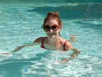 Big tit redhead amateur Essie Halladay having fun in a swimming pool