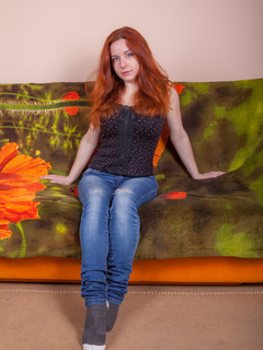 Natural redhead Sara Nikol uncorks her big naturals as she strips naked