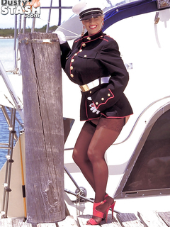 Older blonde babe Busty Dusty freeing huge boobs from uniform outdoors